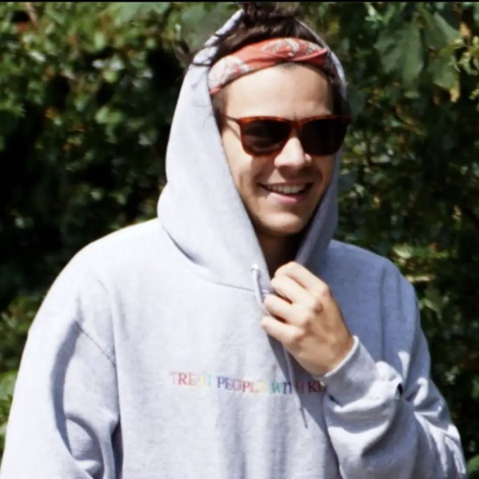 Harry Styles covers up with a mask, hoodie and shades during