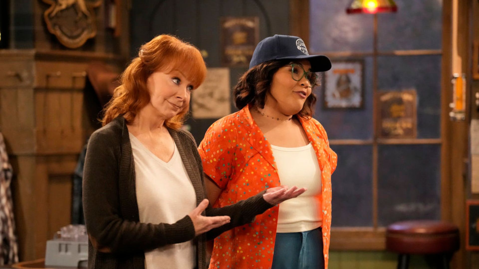 HAPPY'S PLACE -- "Happy's House" Episode 106 -- Pictured: (l-r) Reba McEntire as Bobbie, Belissa Escobedo as Isabella -- (Photo by: Casey Durkin/NBC)