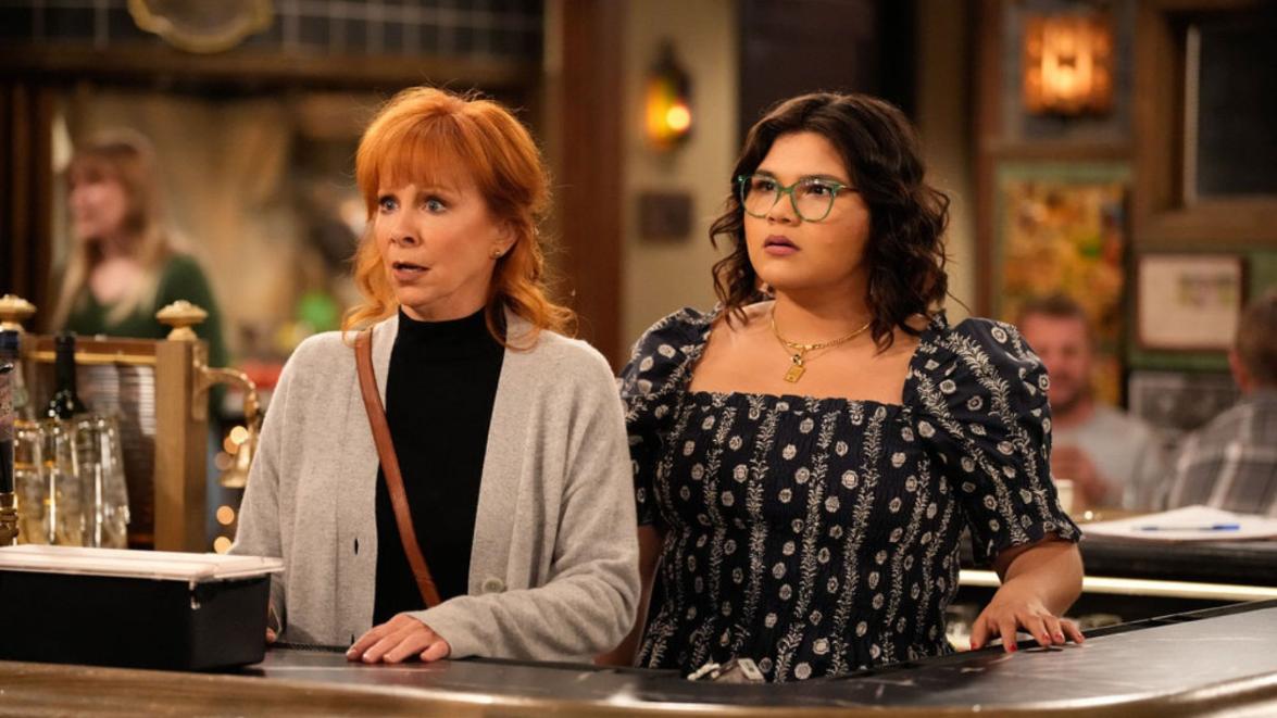 HAPPY'S PLACE -- "Acountability" Episode 114 -- Pictured: (l-r) Reba McEntire as Bobbie, Belissa Escobedo as Isabella -- (Photo by: Casey Durkin/NBC)