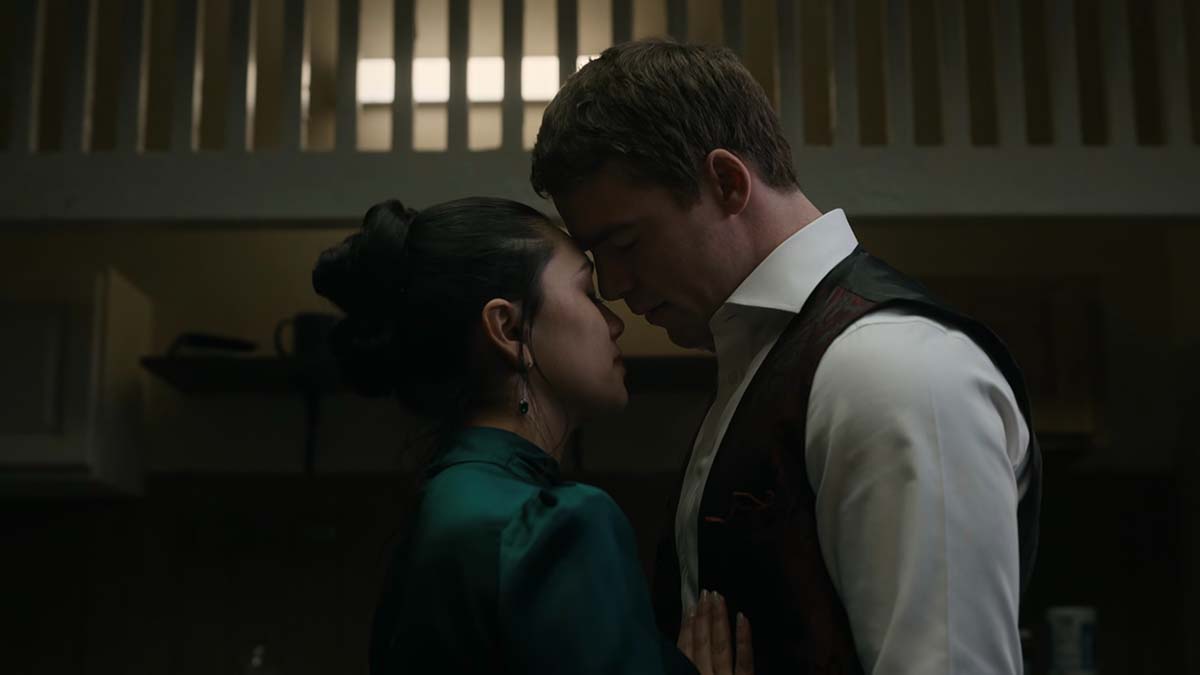 Peter and Rose with their heads together in The Night Agent Season 2.