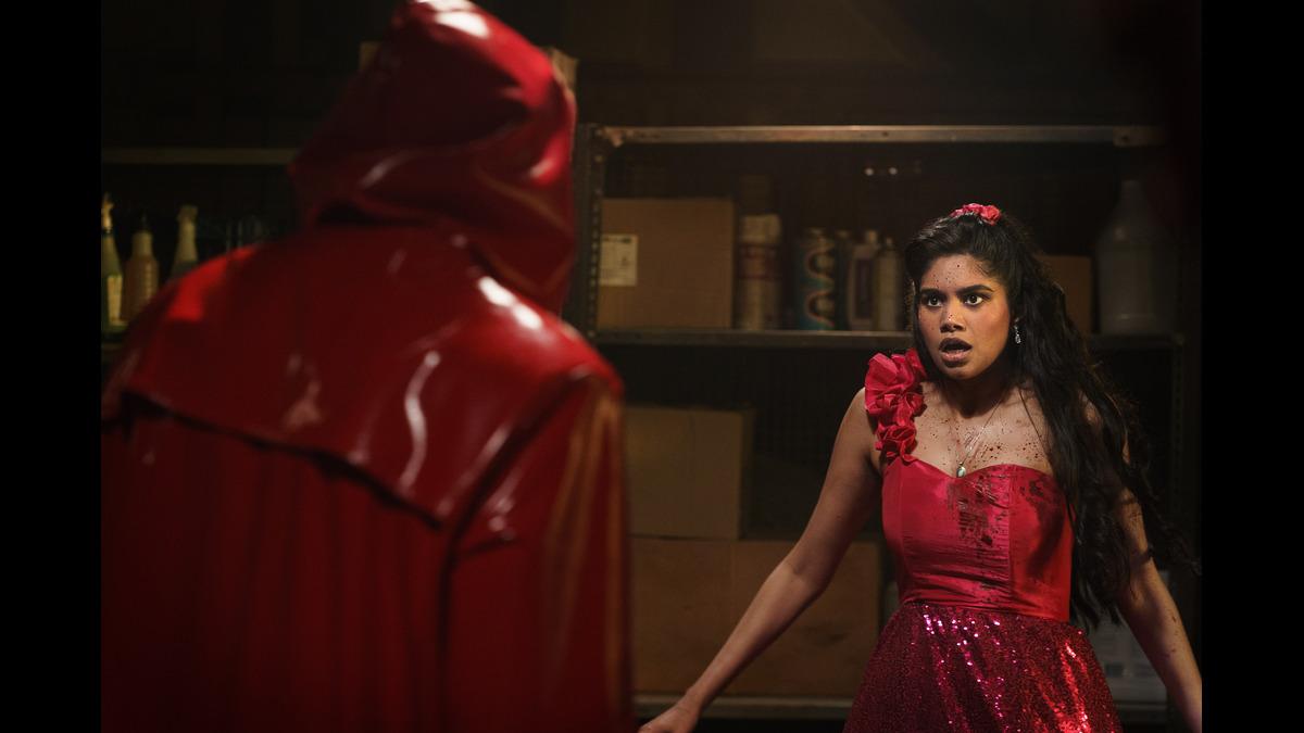 A masked killer confronting a prom-goer in Fear Street: Prom Queen.