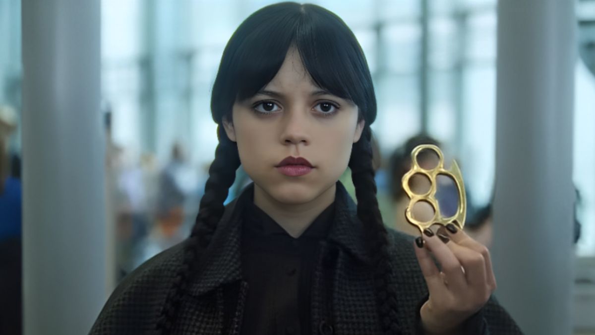 Jenna Ortega as Wednesday Addams in the Season 2 teaser, standing at an airport