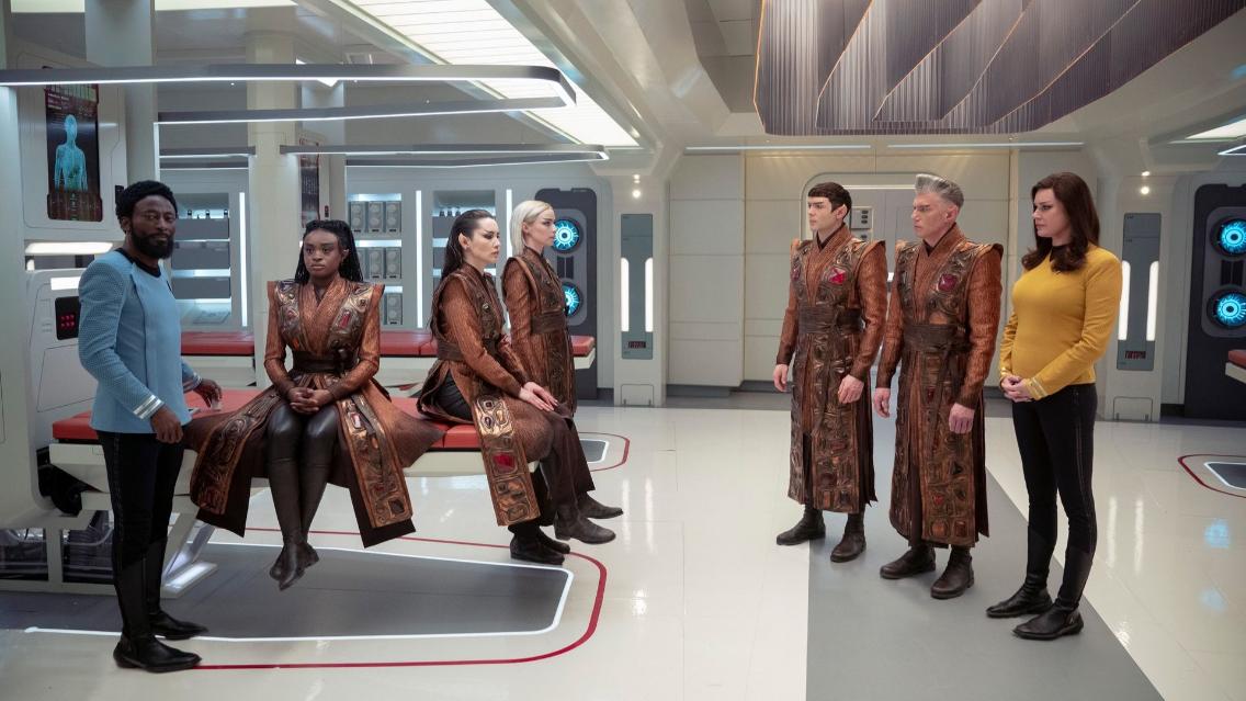 Babs Olusanmokun as Dr. M'Benga, Celia Rose Gooding as Uhura, Christina Chong as La'an, Jess Bush as Nurse Chapel, Ethan Peck as Spock, Anson Mount as Captain Pike, and Rebecca Romijn as Una Chin-Riley in Star Trek: Strange New Worlds season 3 episode 8 "Four-and-a-Half Vulcans."