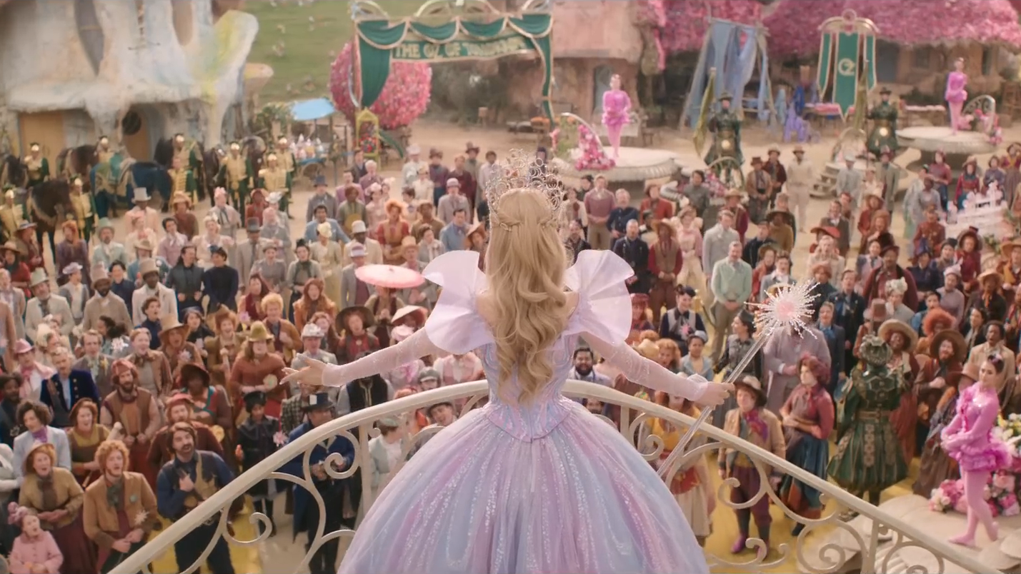 Ariana Grande as Glinda before the people of Munchkinland in 'Wicked: For Good' trailer