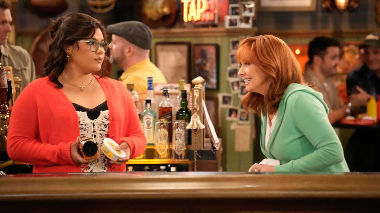 HAPPY'S PLACE -- "Izzy & the Professor" Episode 206 -- Pictured: (l-r) Belissa Escobedo as Isabella, Reba McEntire as Bobbie -- (Photo by: Casey Durkin/NBC)