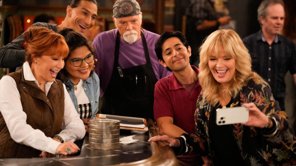 HAPPY'S PLACE -- "The Name Game" Episode 208 -- Pictured: (l-r) Reba McEntire as Bobbie, Belissa Escobedo as Isabella, Tokala Black Elk as Takoda, Rex Linn as Emmett, Pablo Castelblanco as Steve, Melissa Peterman as Gabby -- (Photo by: Casey Durkin/NBC)