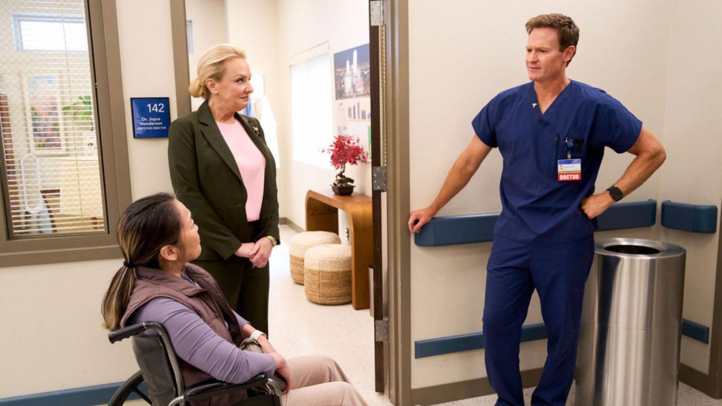 ST. DENIS MEDICAL -- "Everyone Loves Portland General" Episode 215 -- Pictured: (l-r) as Camille Jacobs, Wendi Mclendon Covey as Joyce, Josh Lawson as Bruce -- (Photo by: Greg Gayne/NBC)