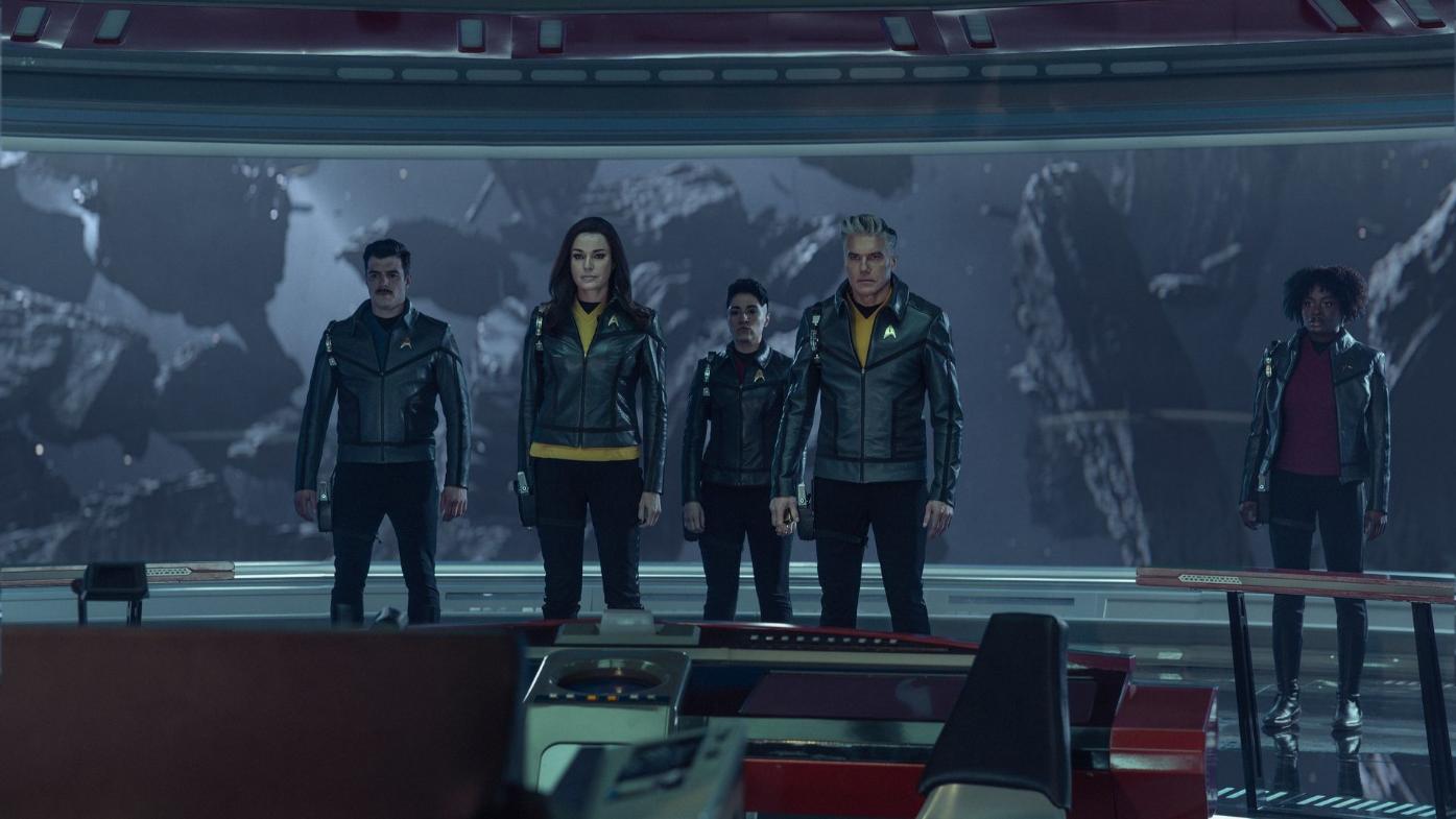 Dan Jeannotte as Sam Kirk, Rebecca Romijn as Una Chin-Riley, Melissa Navia as Erica Ortegas, Anson Mount as Captain Pike, and Celia Rose Gooding as Uhura in season 4 episode 2 of Star Trek: Strange New Worlds.